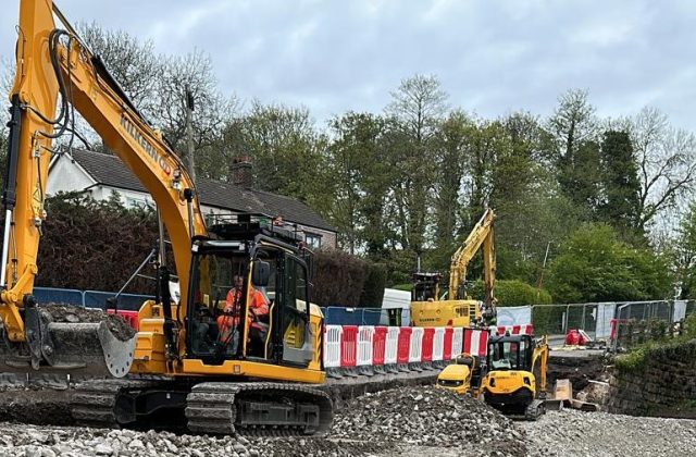 Construction plant working to repair the road at Soot Hill, Northwich, Cheshire