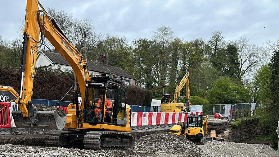 Construction plant working to repair the road at Soot Hill, Northwich, Cheshire