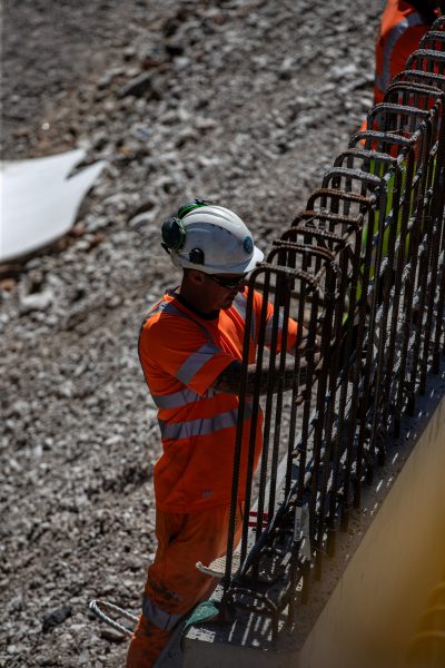 Workers from civil engineering specialist Kilkern carry out remediation work, installing a section of a new king post-piled retaining wall at Soot Hill, Northwhich, Cheshire. 10/08/23
